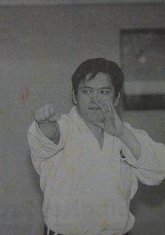 Shihan Michael Sim in a karate stance, in a gi