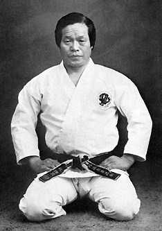 Soke Teruo Hayashi, seated in seiza in a karate gi and black belt